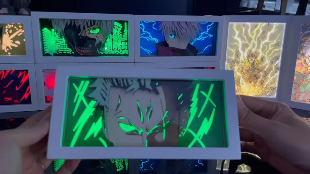 Anime light box sa osvetljenim likovima i efektima u pozadini